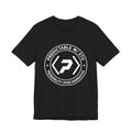 Front of the black PREDICTABLE Badge Crest Tee showing the chest graphic.
