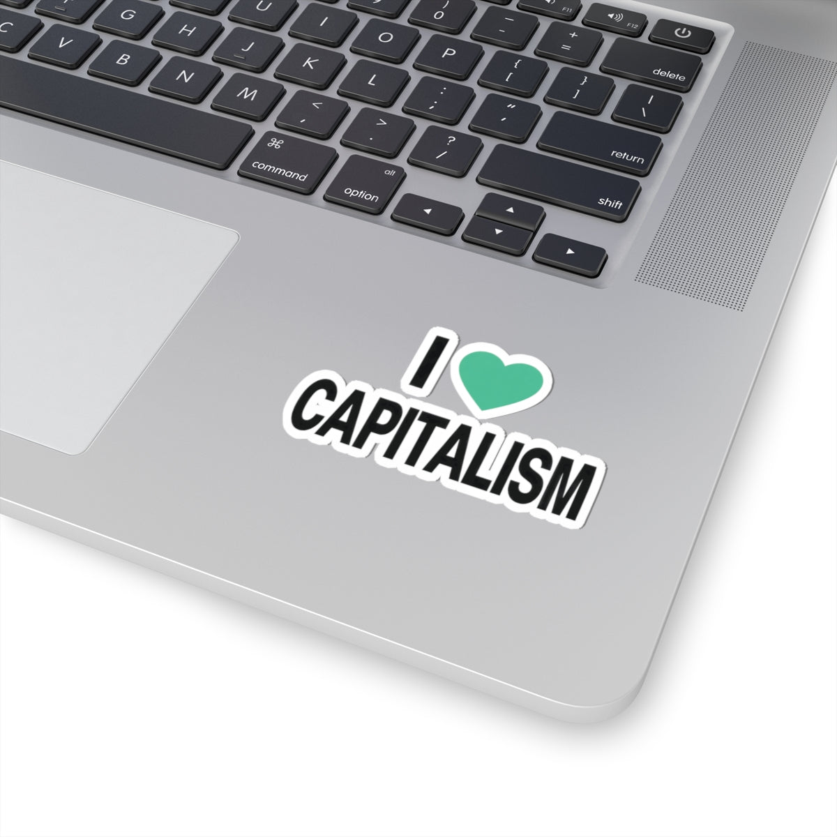 No-logo I Heart Capitalism sticker with mint heart and black lettering shown on a laptop