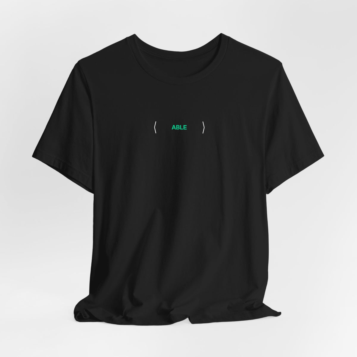Black PREDICTABLE ABLE (Stealth) Unisex Tee draped against a light gray backdrop.