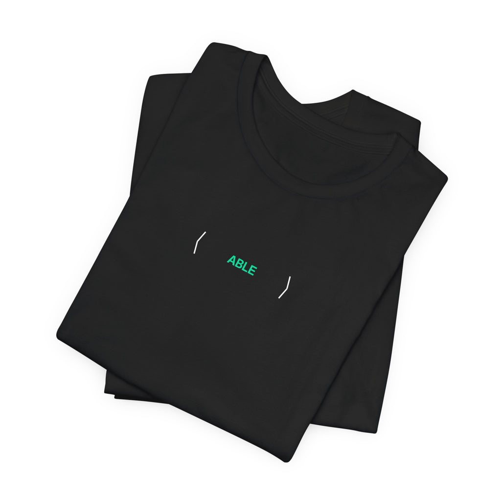 Folded black PREDICTABLE ABLE (Stealth) Unisex Tee showing the front graphic.